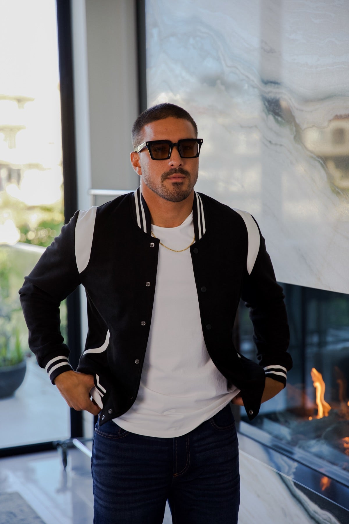 Man in a black varsity jacket