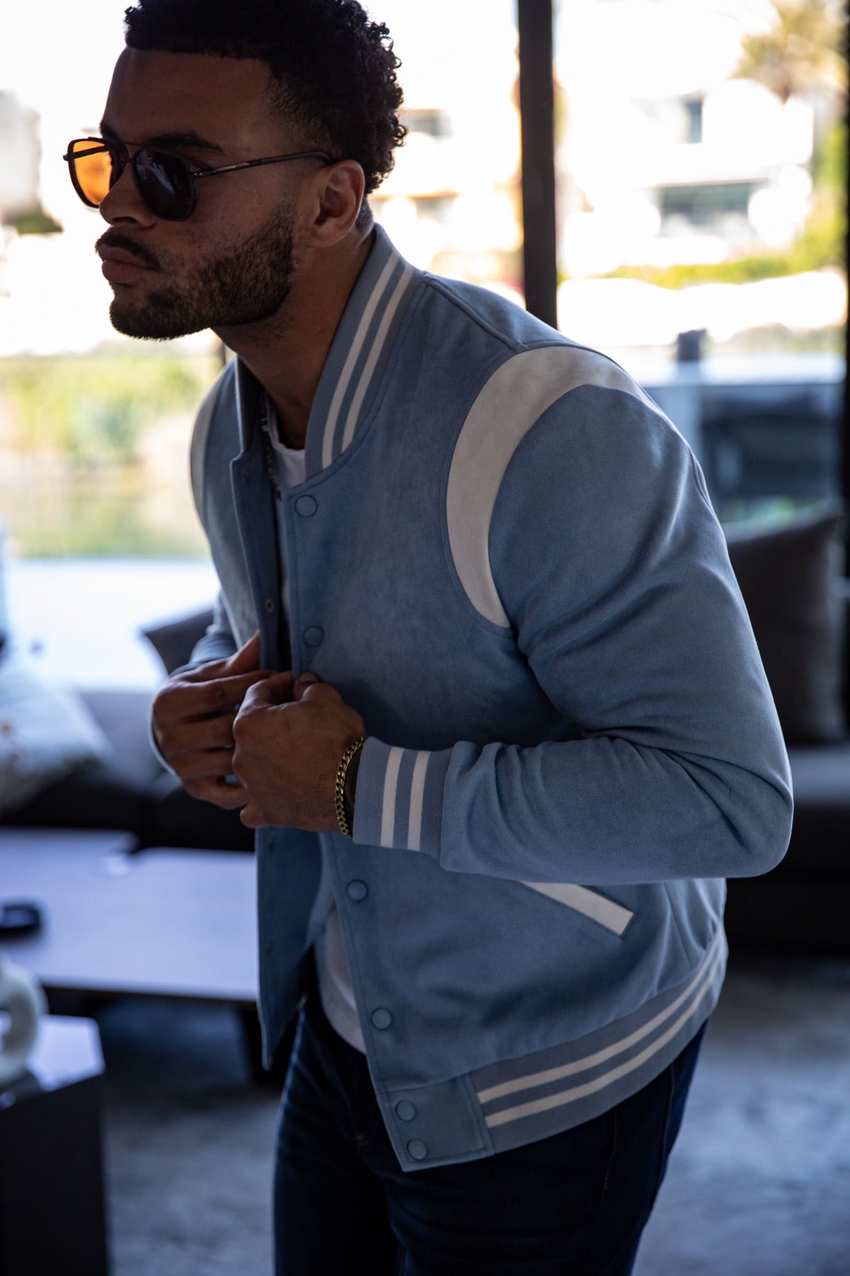 Man in a blue varsity jacket