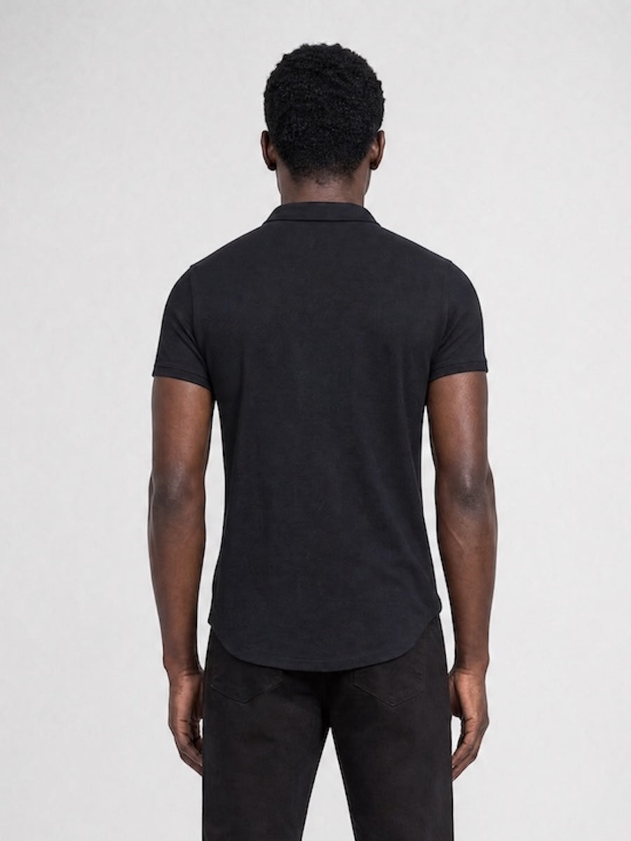 Back profile of MONFRÈRE Bond Polo Noir men's black stretch viscose polo shirt.
