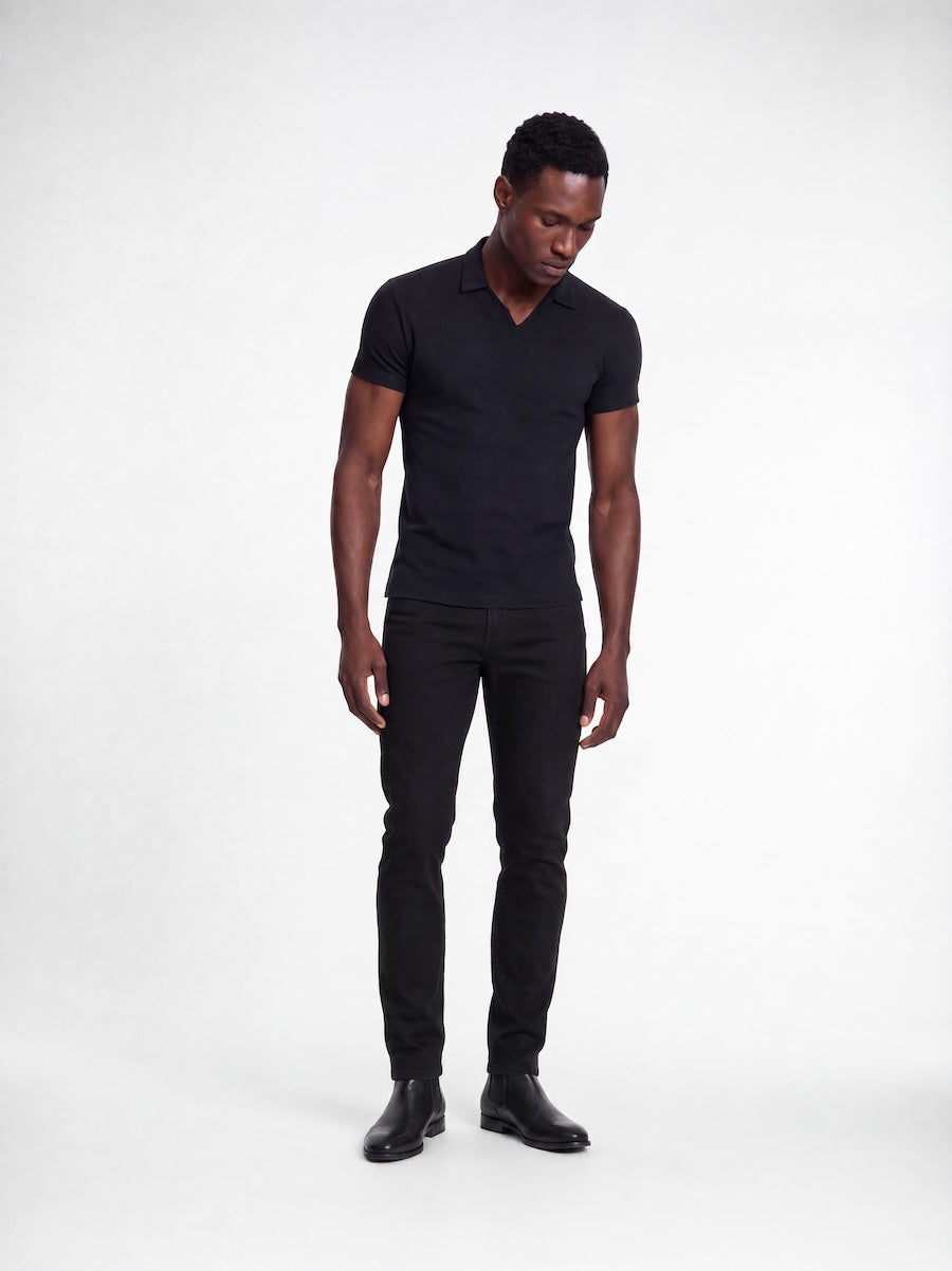 Model wearing MONFRÈRE Bond Polo Noir men's black stretch viscose polo shirt.