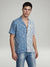 Front profile of MONFRÈRE Bond Shirt Silk Outlaw men's paisly blue and cream stretch viscose silk bowling shirt.
