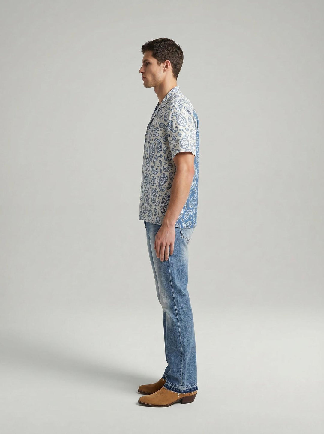 Side profile of MONFRÈRE Bond Shirt Silk Outlaw men's paisly blue and cream stretch viscose silk bowling shirt.