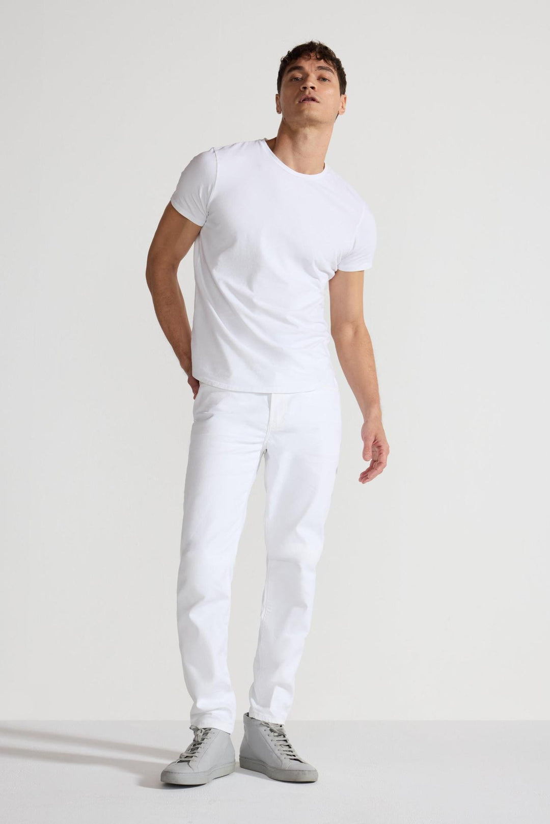 Model wearing MONFRÈRE Brando Blanc men's white Japanese stretch denim five pocket slim jean.