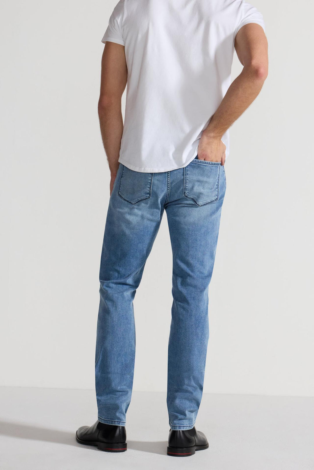 Back profile of MONFRÈRE Brando Florentine men's blue Japanese stretch denim five pocket slim jean.