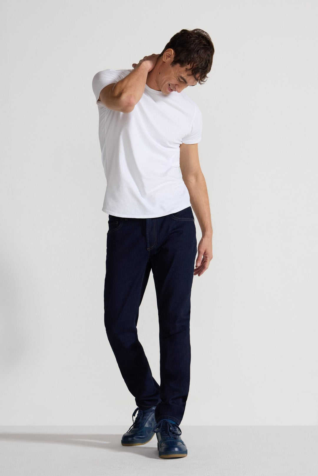 Model wearing MONFRÈRE Brando Indigo men's dark blue Japanese stretch denim five pocket slim jean.