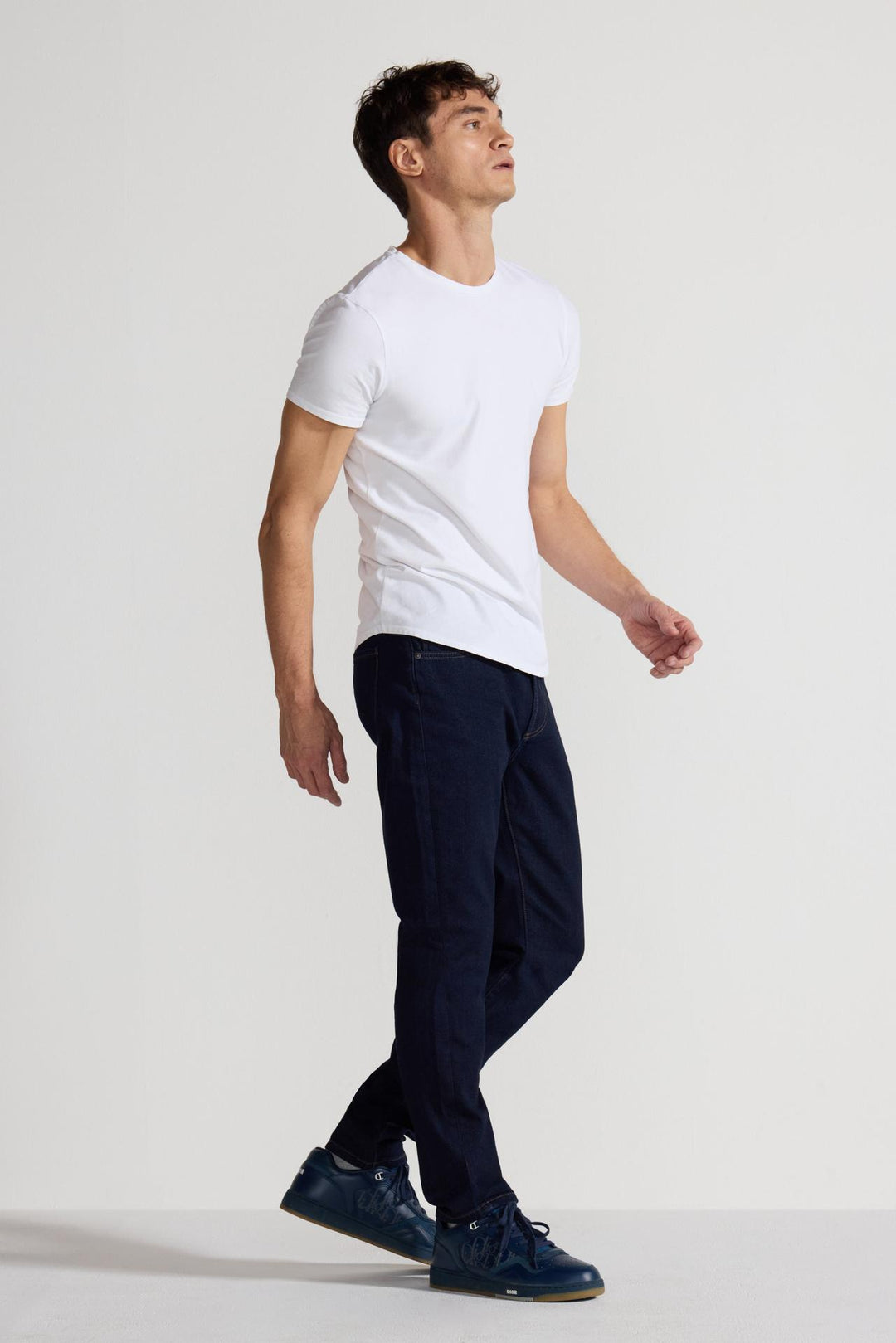 Side profile of MONFRÈRE Brando Indigo men's dark blue Japanese stretch denim five pocket slim jean.