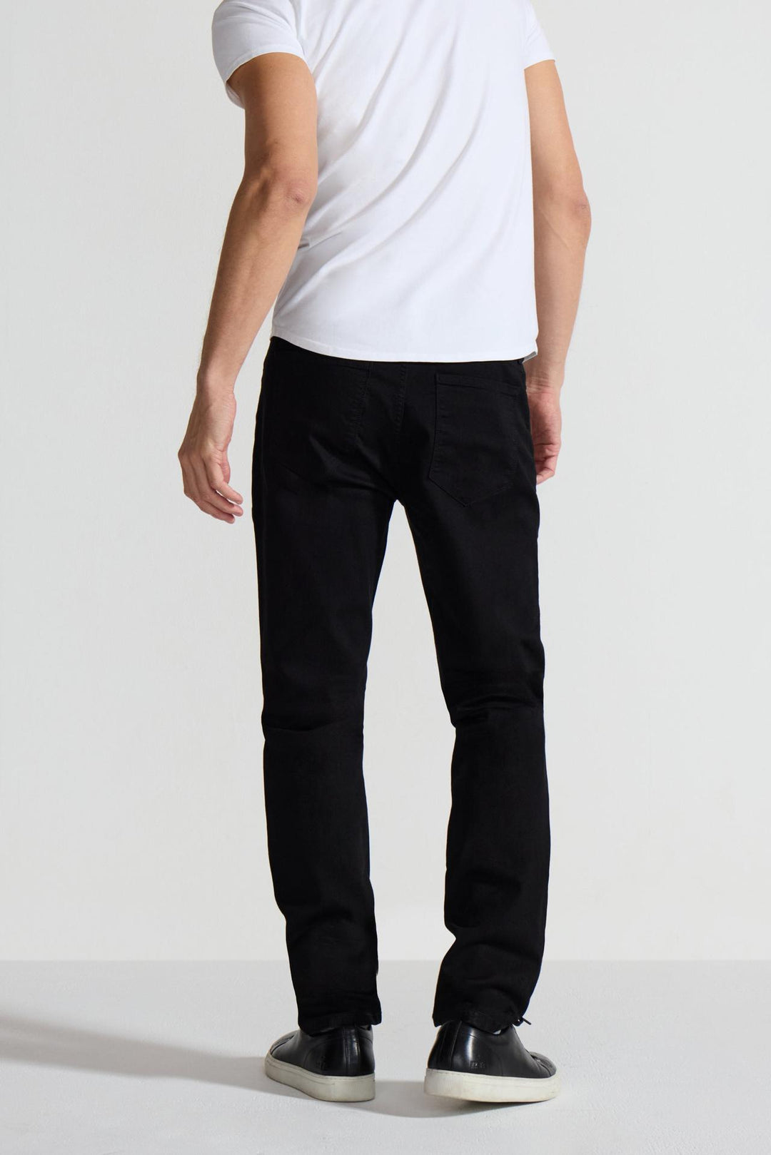 Back profile of MONFRÈRE Brando Noir men's black Japanese stretch denim five pocket slim jean.
