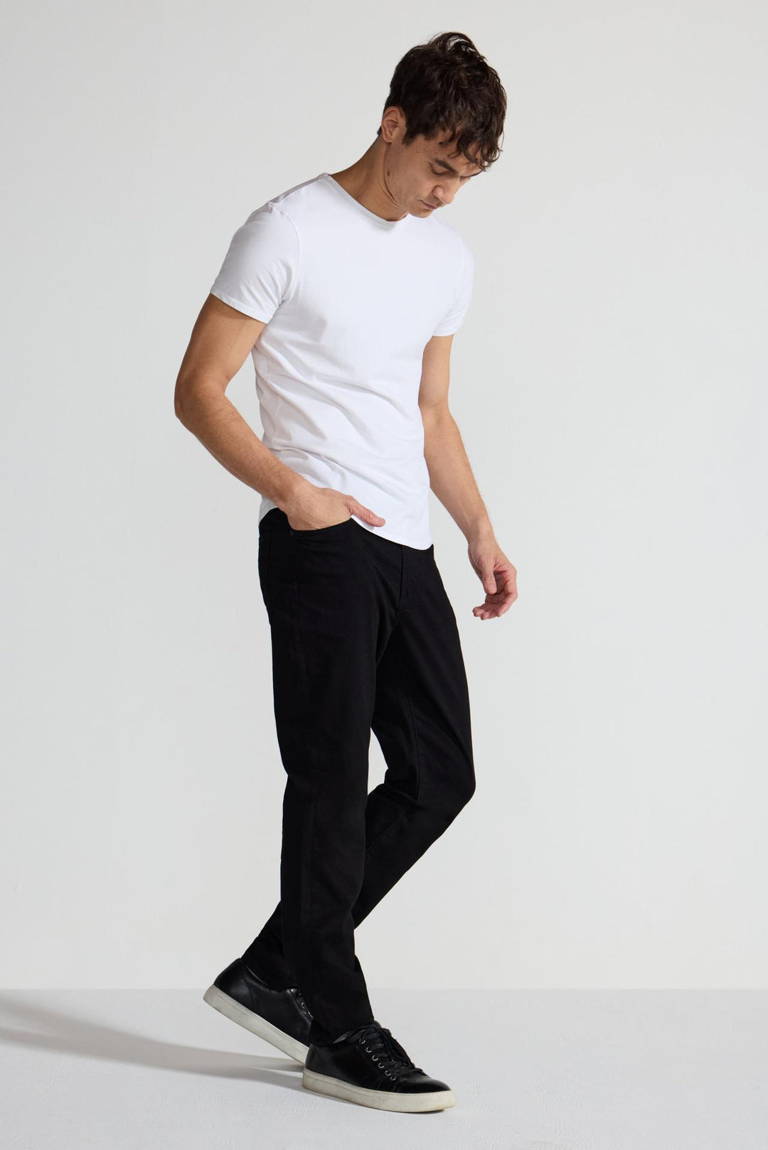 Side profile of MONFRÈRE Brando Noir men's black Japanese stretch denim five pocket slim jean.