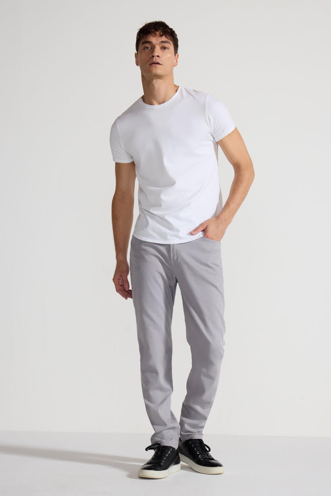 Model wearing MONFRÈRE Brando Parisian Luxe Light Grey men's grey soft stretch twill five pocket slim jean.