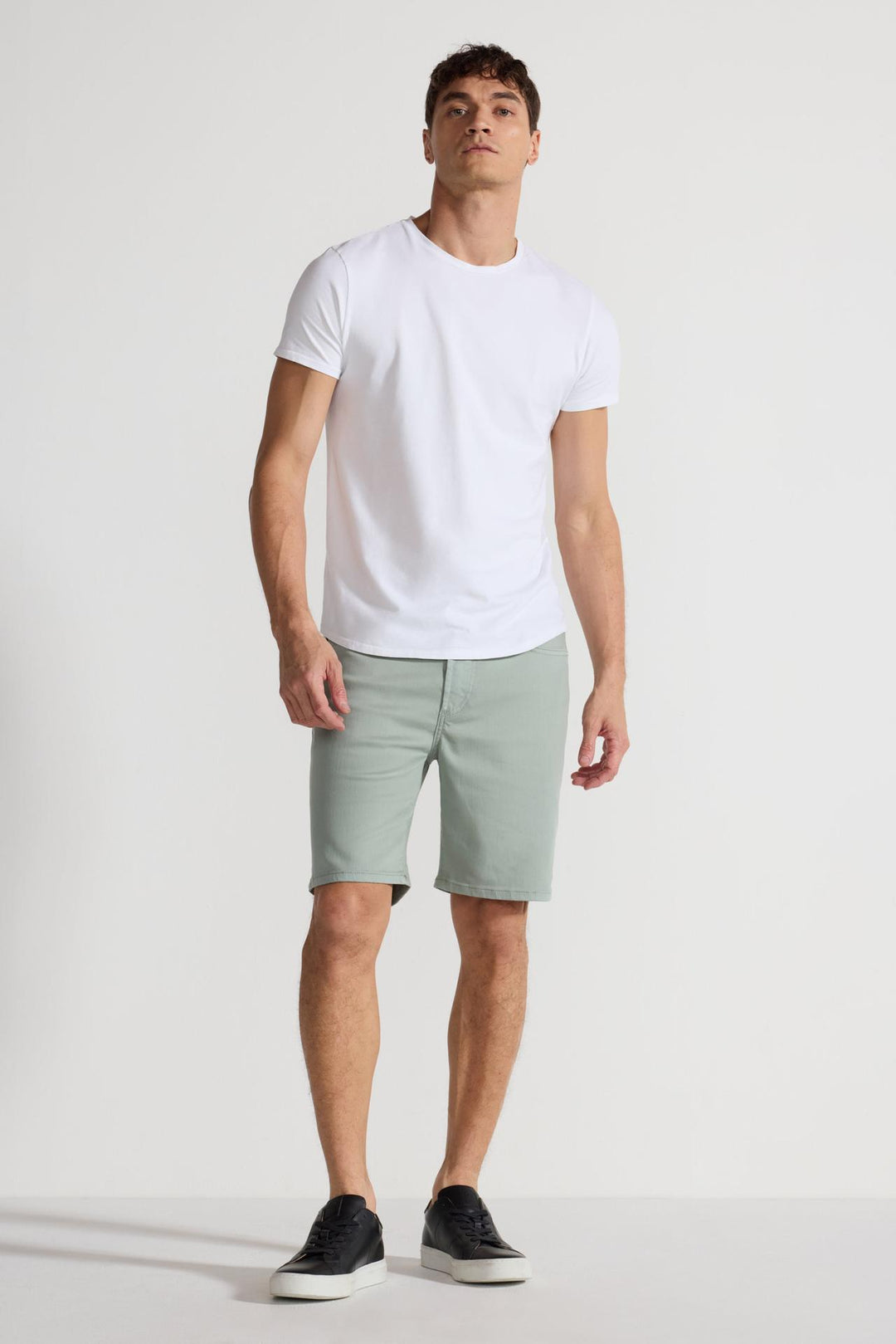 Model wearing MONFRÈRE Brando Short Mineral Green men's green soft stretch twill five pocket short.