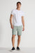 Model wearing MONFRÈRE Brando Short Mineral Green men's green soft stretch twill five pocket short.