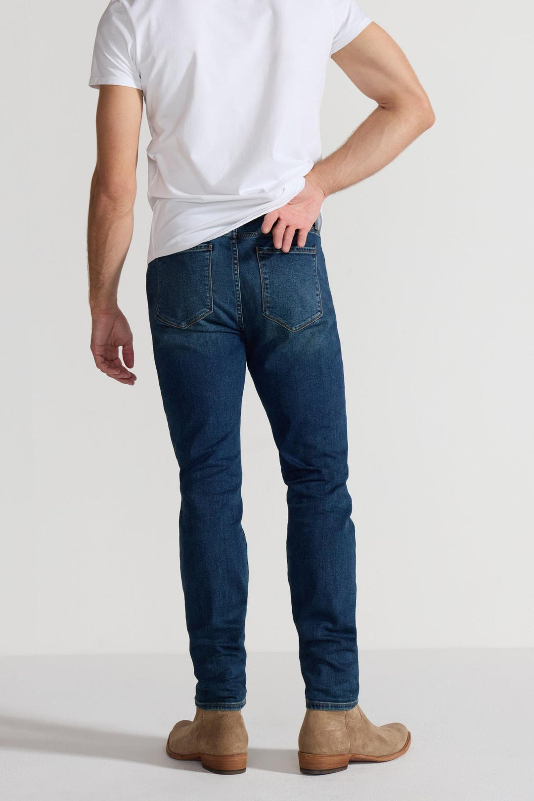 Back profile of MONFRÈRE Brando Tinted Indigo men's dark blue Japanese stretch denim five pocket slim jean.