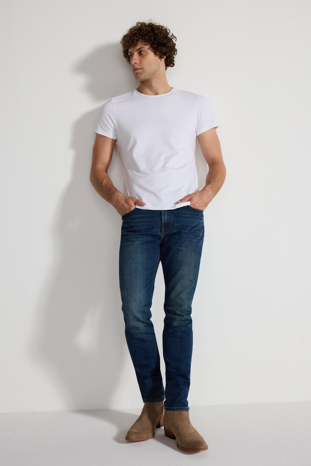 Model wearing MONFRÈRE Brando Tinted Indigo men's dark blue Japanese stretch denim five pocket slim jean.