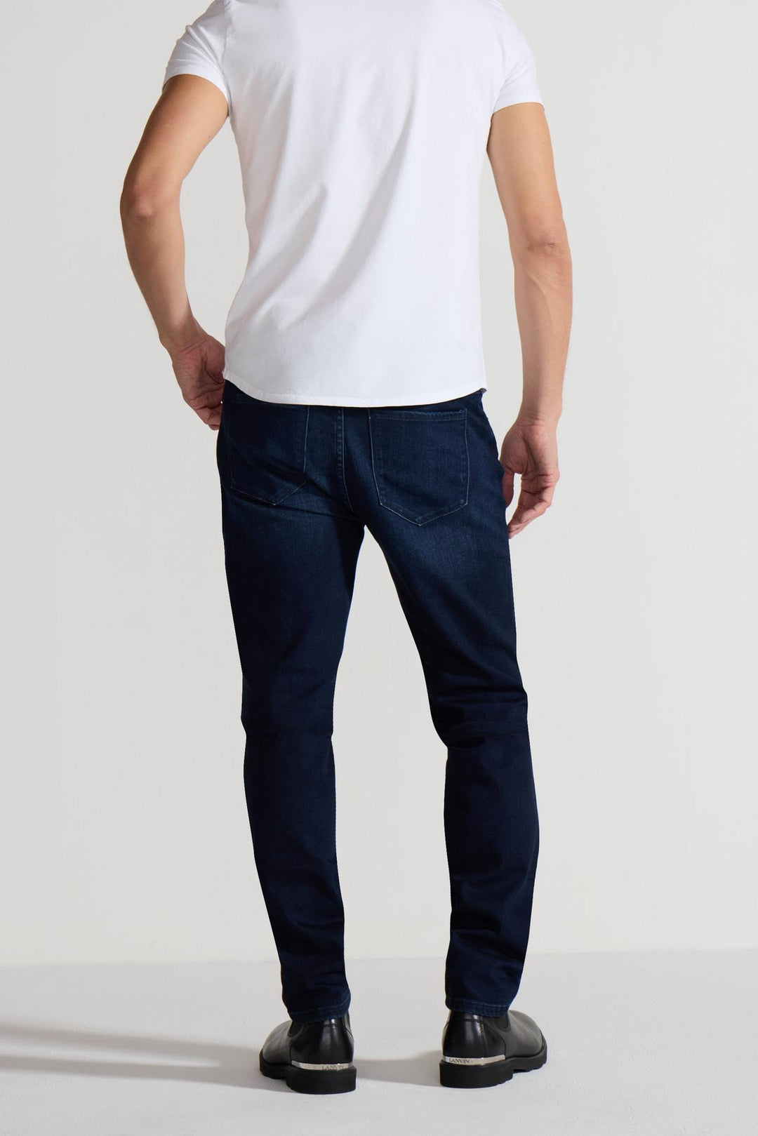 Back profile of MONFRÈRE Brando Vail men's dark blue Japanese stretch denim five pocket slim jean.
