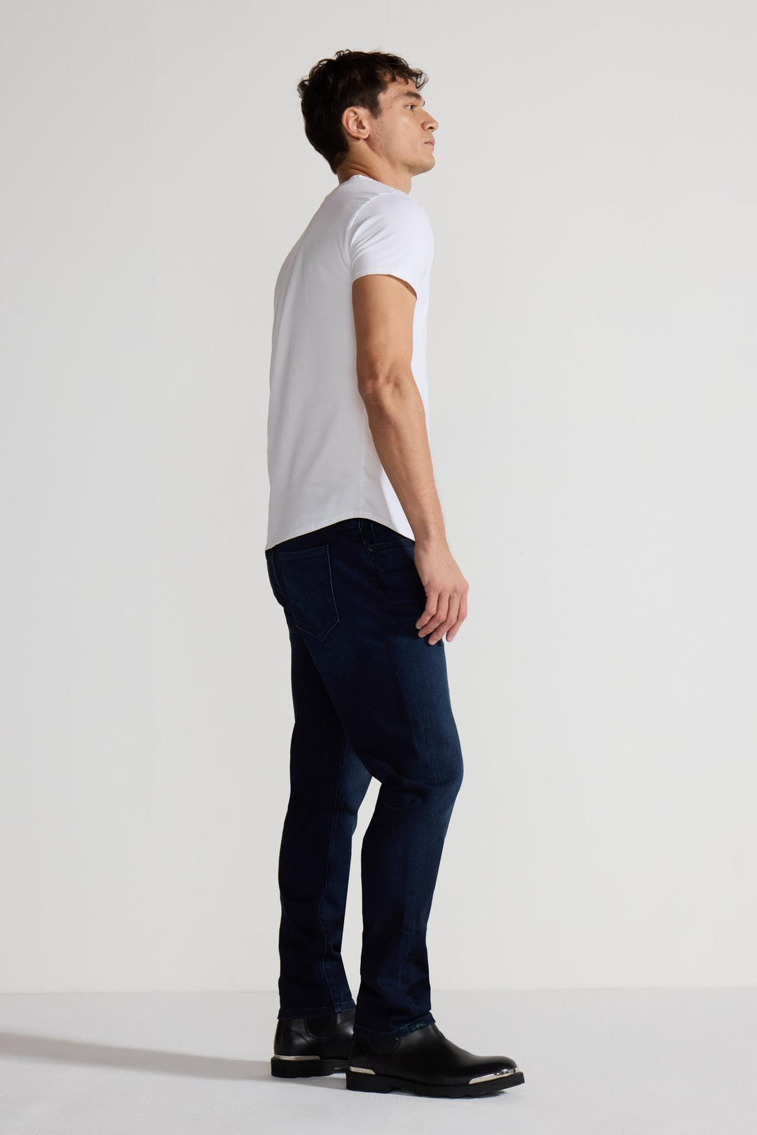 Side profile of MONFRÈRE Brando Vail men's dark blue Japanese stretch denim five pocket slim jean.