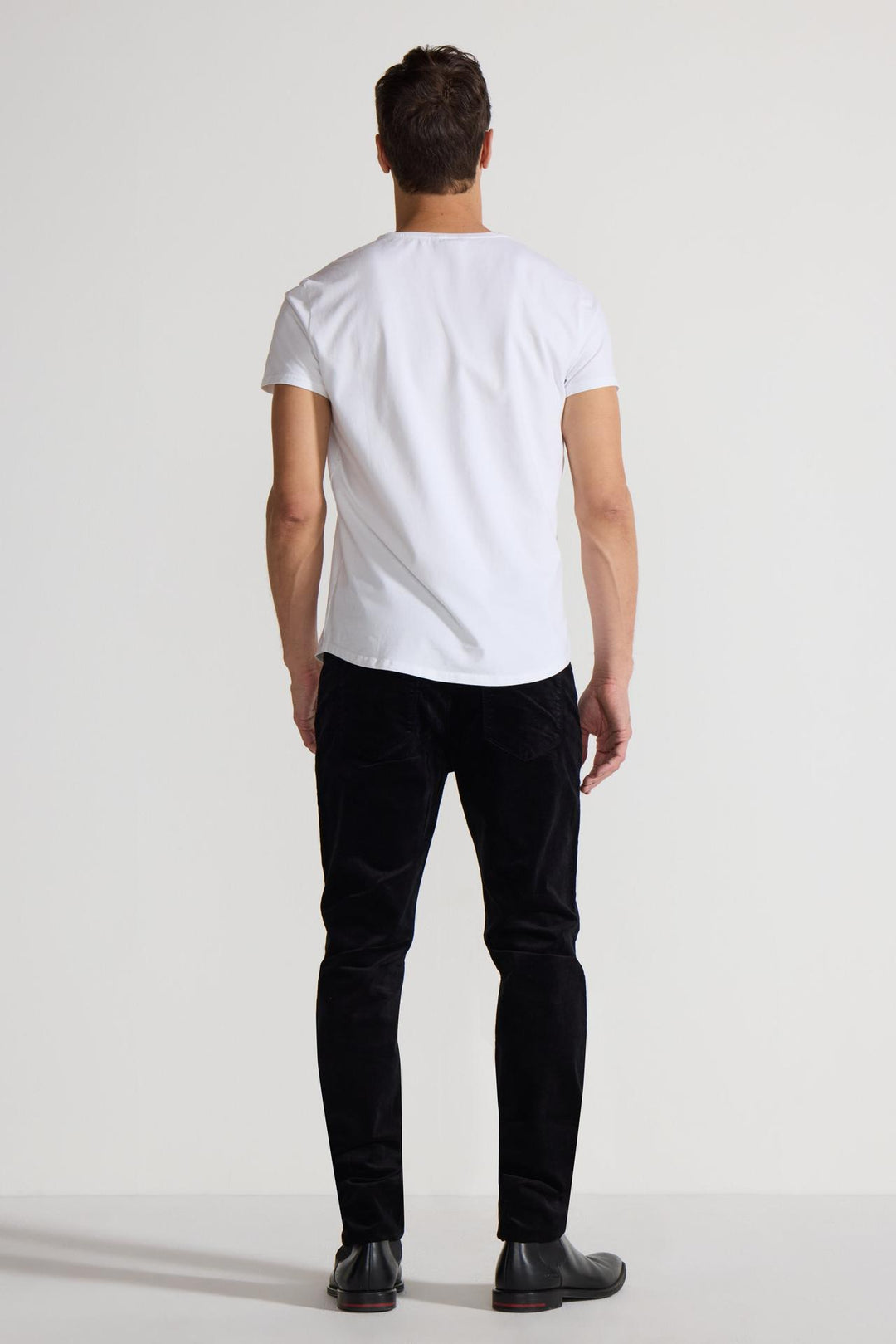 Back profile of MONFRÈRE Brando Velvet Noir men's black velveteen stretch fabric five pocket slim jean.