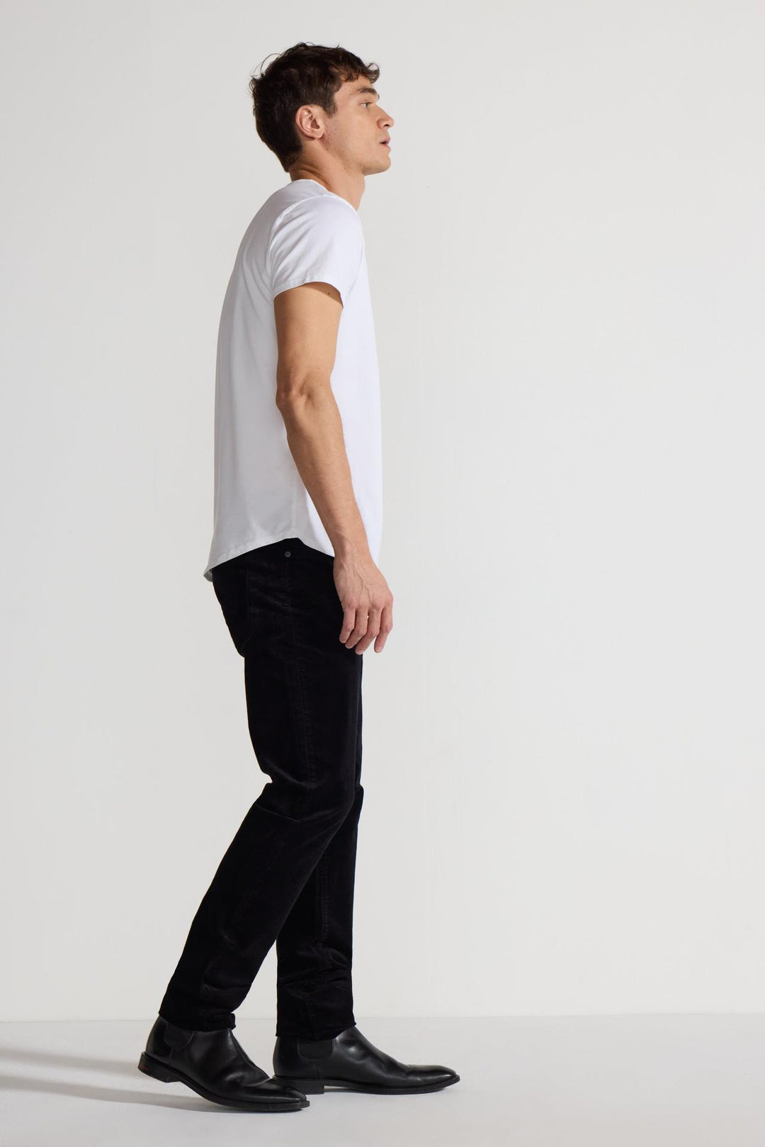 Side profile of MONFRÈRE Brando Velvet Noir men's black velveteen stretch fabric five pocket slim jean.