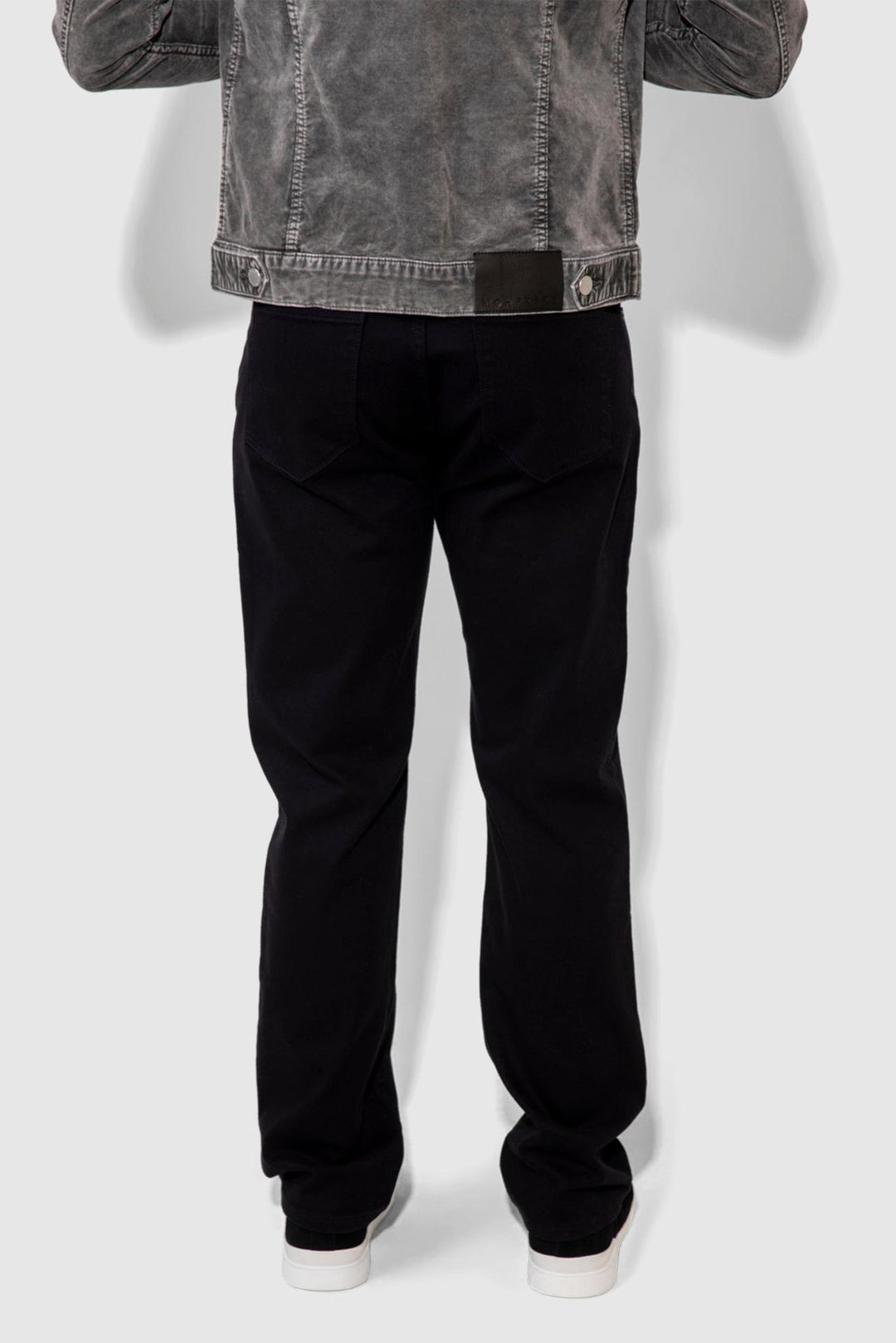 Back profile of MONFRÈRE Caine Noir men's black Japanese stretch denim five pocket straight leg relaxed jean.