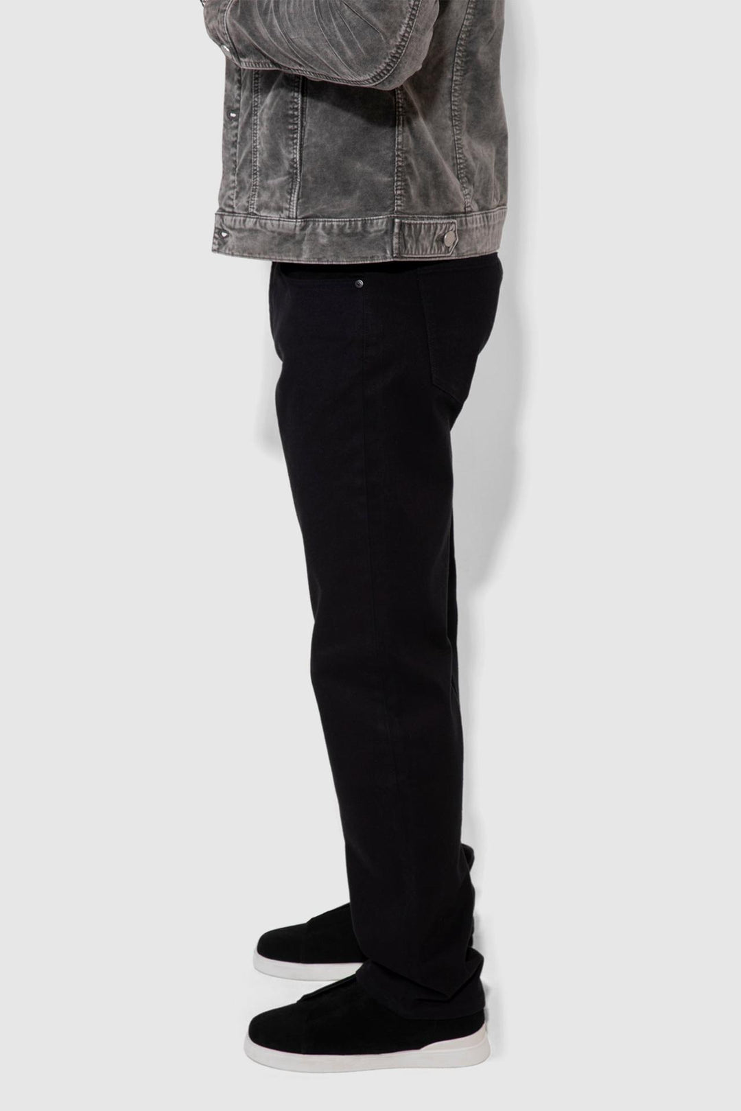 Side profile of MONFRÈRE Caine Noir men's black Japanese stretch denim five pocket straight leg relaxed jean.
