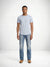 Model wearing MONFRÈRE Clint Aura men's blue rigid denim bootcut jean.