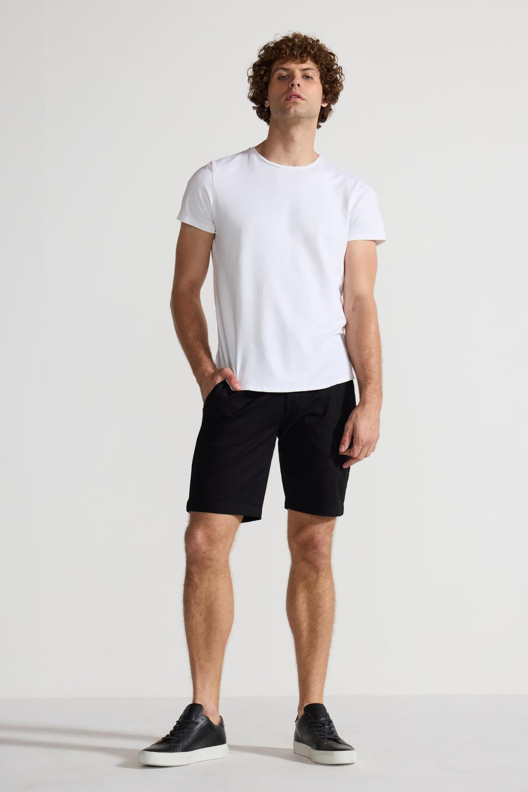 Model wearing MONFRÈRE Cruise Noir men's black Japanese tencel twill chino short.