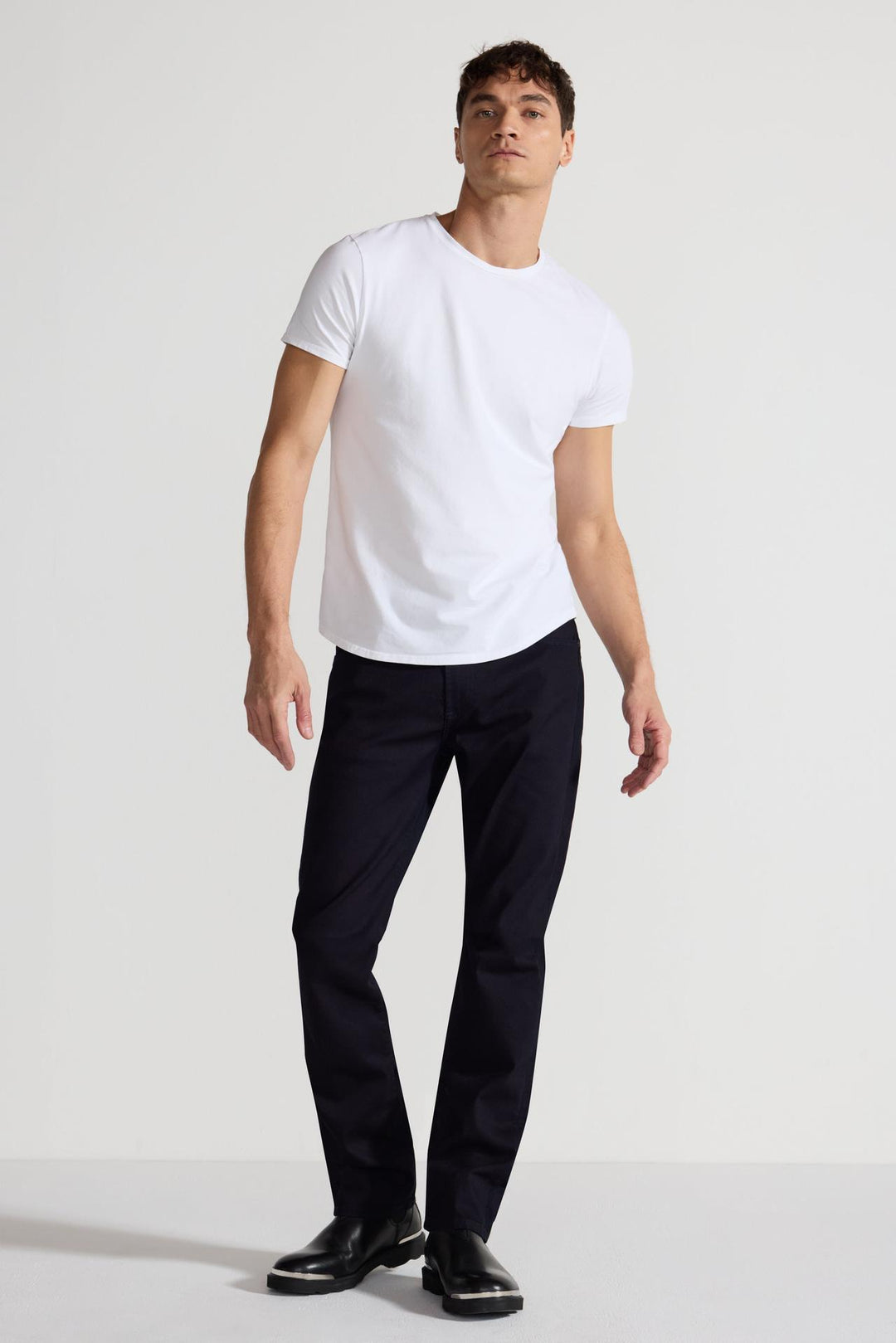 Model wearing MONFRÈRE Dann Blanc men's white stretch jersey knit short sleeve t-shirt.