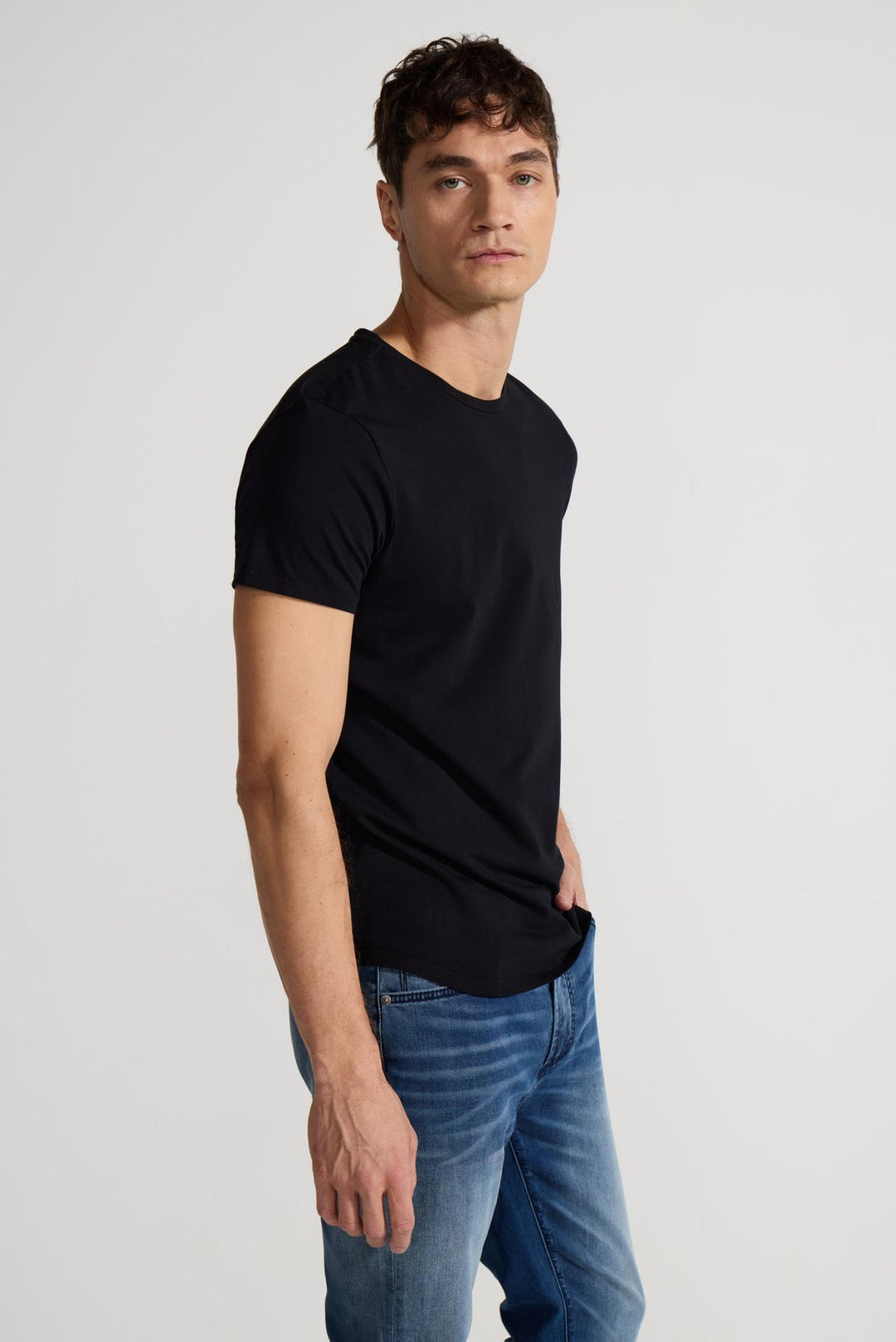 Side profile of MONFRÈRE Dann Noir men's black stretch jersey knit short sleeve t-shirt.