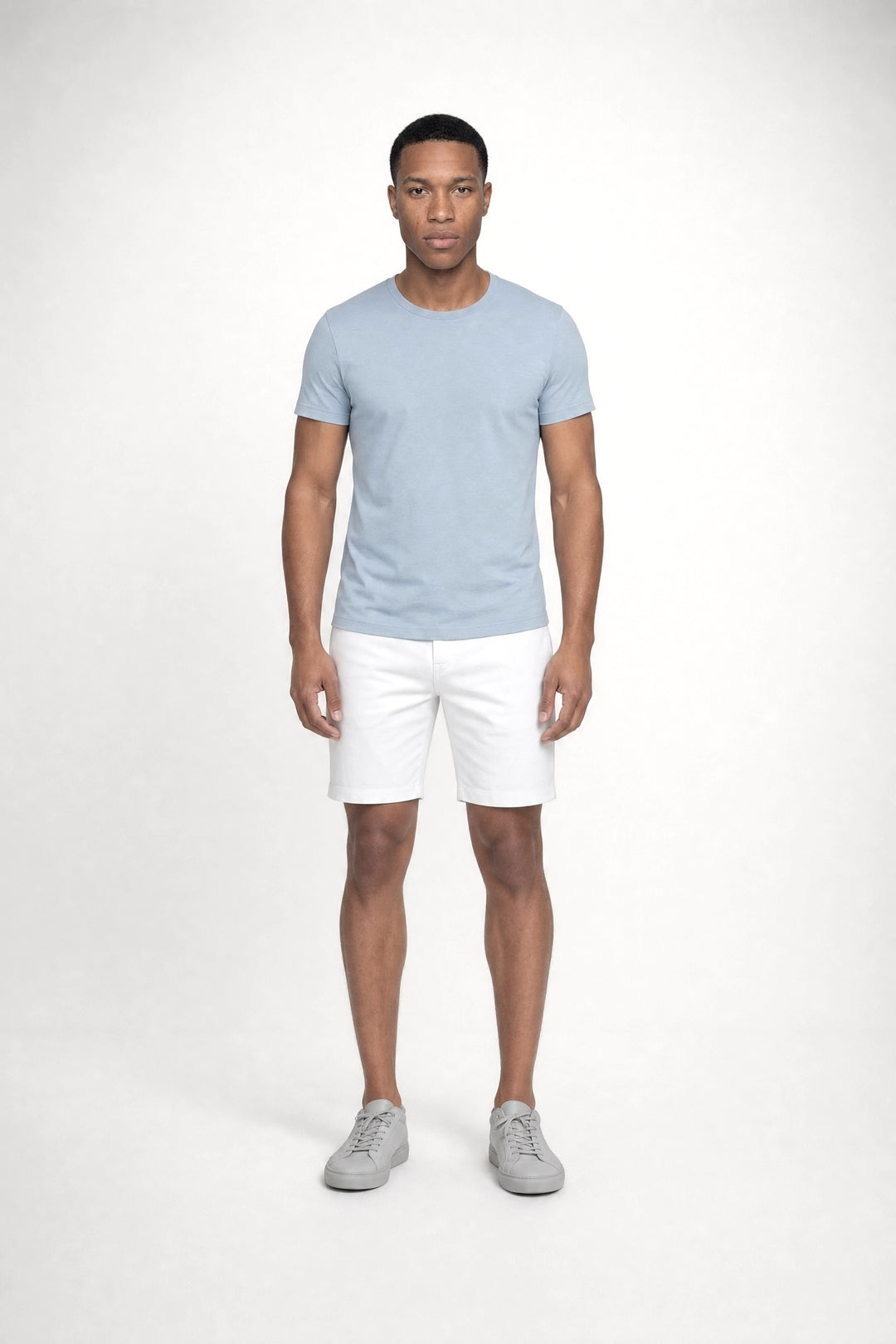 Model wearing MONFRÈRE Dann Steel Blue men's light blue stretch jersey knit short sleeve t-shirt.