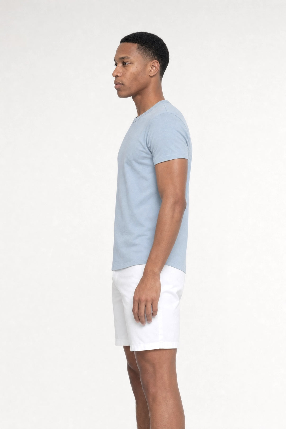 Side profile of MONFRÈRE Dann Steel Blue men's light blue stretch jersey knit short sleeve t-shirt.