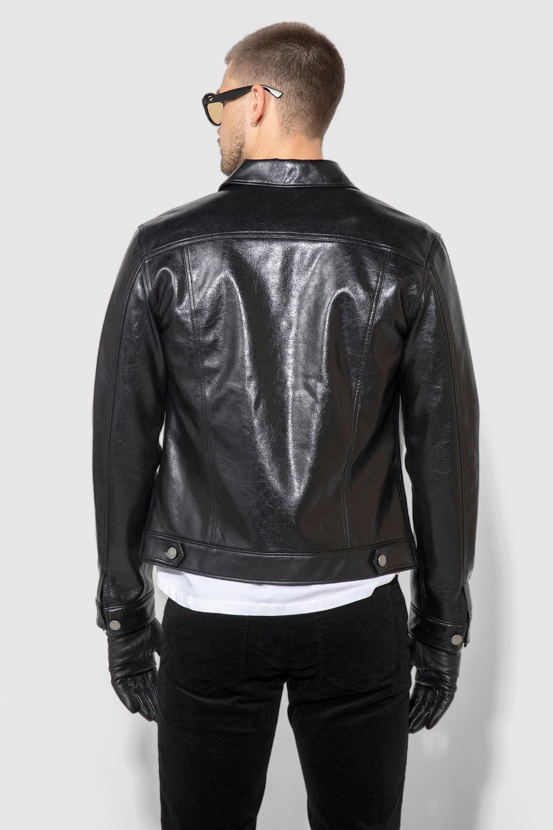 Back profile of MONFRÈRE Dean Patent Noir men's black stretch vegan leather trucker jacket.
