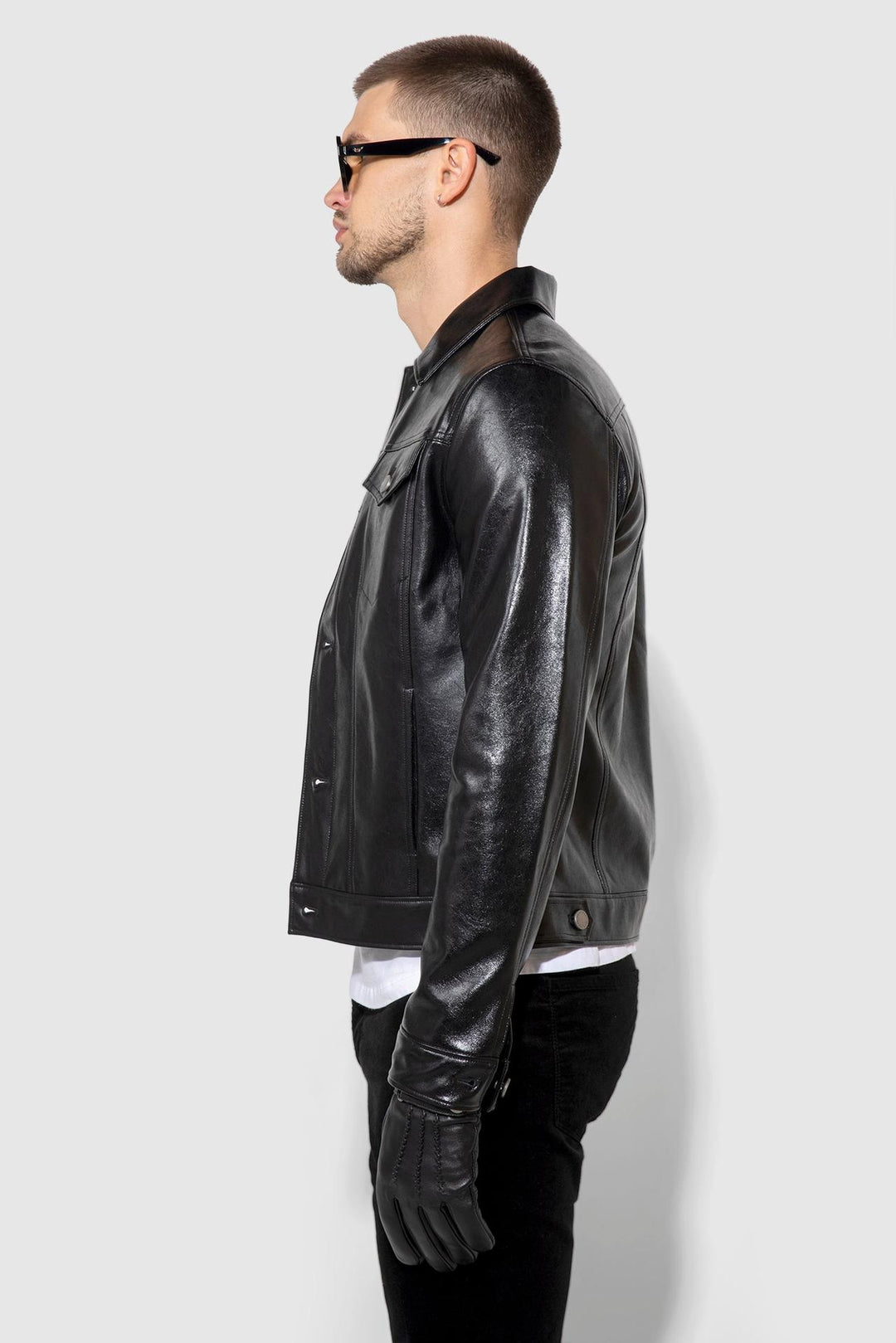 Side profile of MONFRÈRE Dean Patent Noir men's black stretch vegan leather trucker jacket.