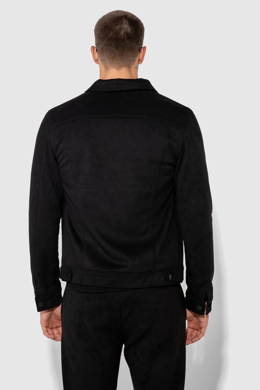 Back profile of MONFRÈRE Dean Butter Suede Noir men's black soft faux suede stretch fabric trucker jacket.