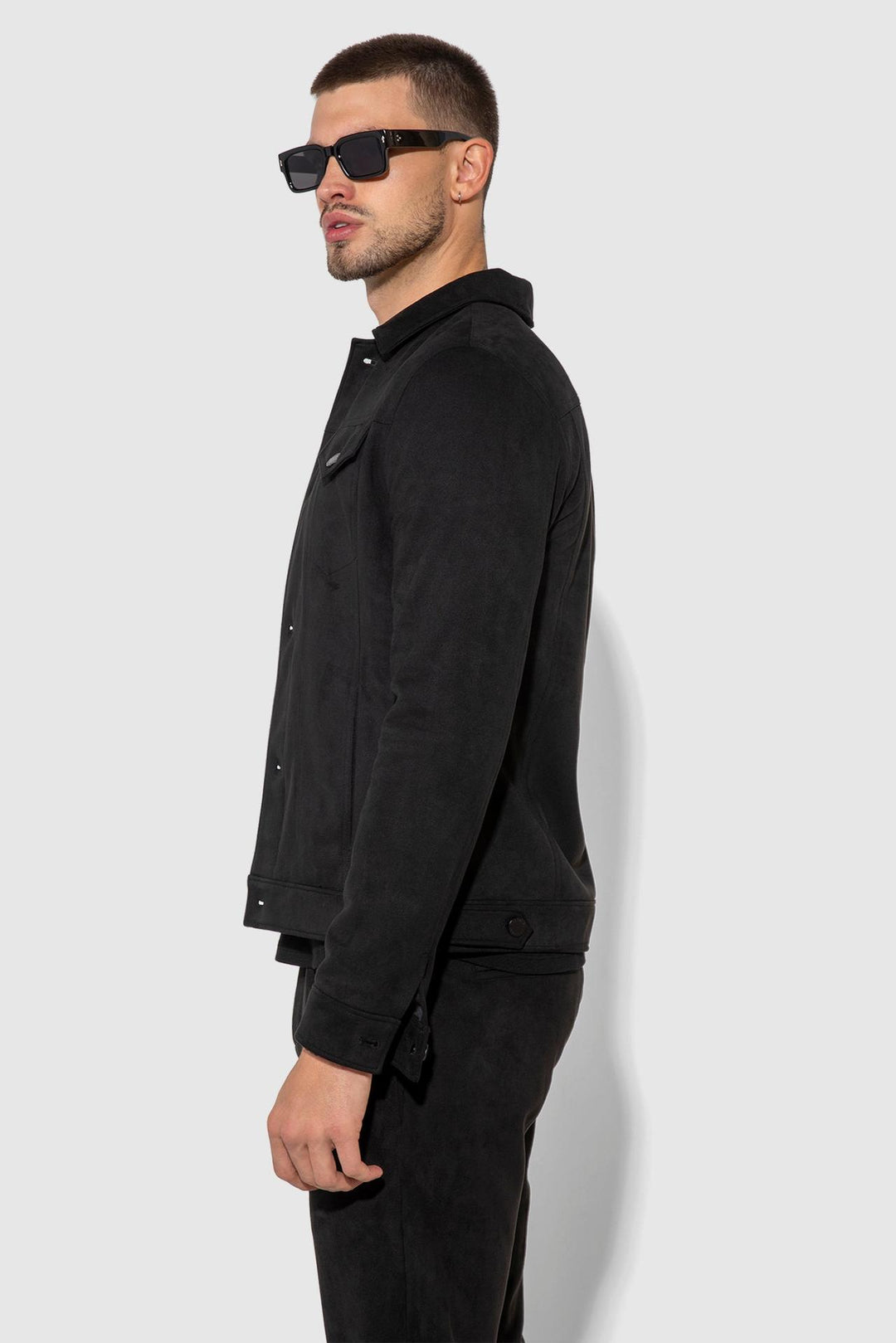 Side profile of MONFRÈRE Dean Butter Suede Noir men's black soft faux suede stretch fabric trucker jacket.