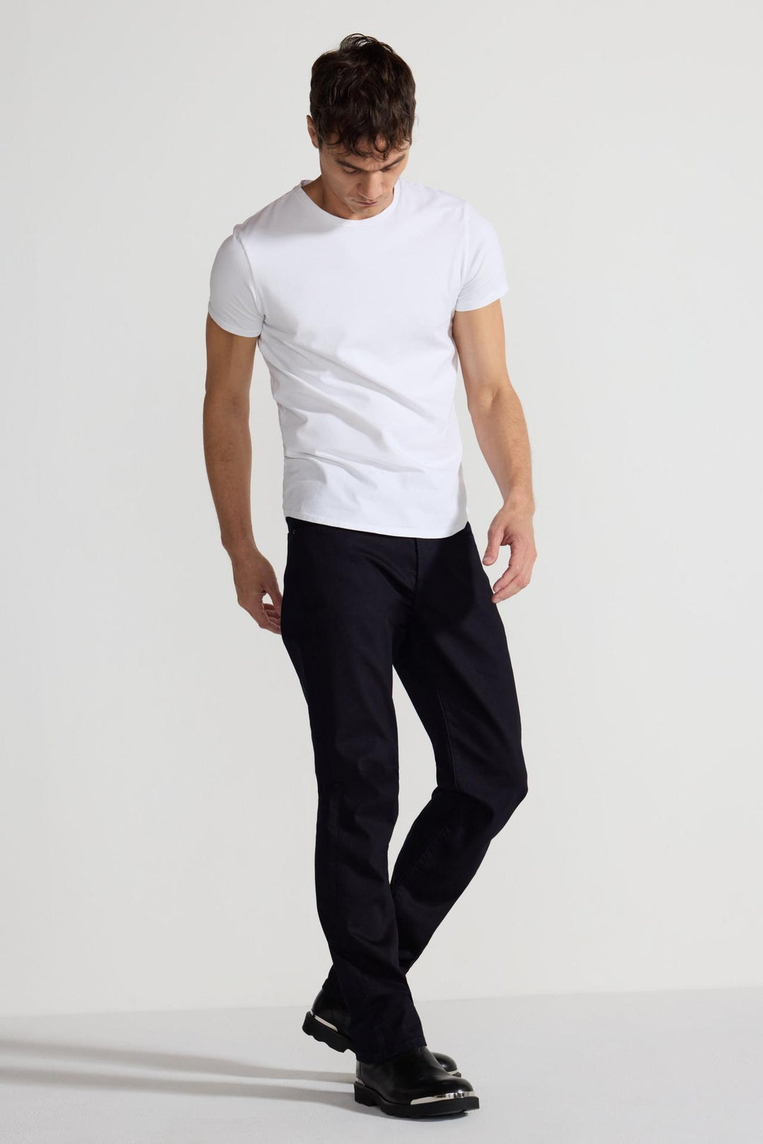 Model wearing MONFRÈRE Deniro Ink men's dark blue navy Japanese stretch denim five pocket slim straight jean.