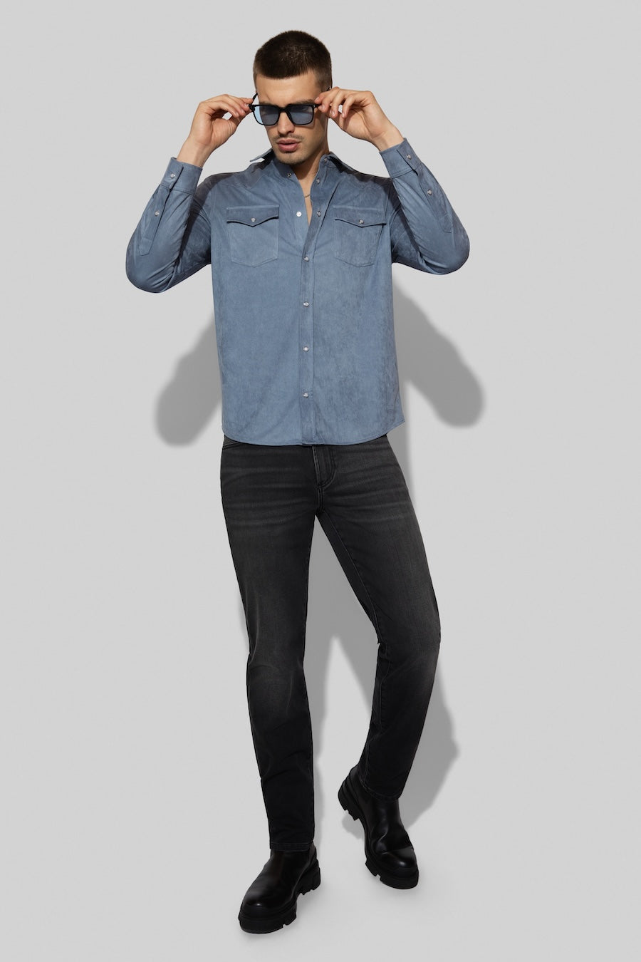 Model wearing MONFRÈRE Eastwood Butter Suede Steel Blue men's blue soft faux suede stretch fabric western shirt.