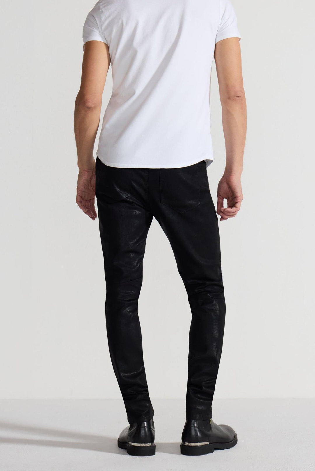 Back profile of MONFRÈRE Greyson Coated Noir men's black coated Japanese stretch denim five pocket skinny jean.