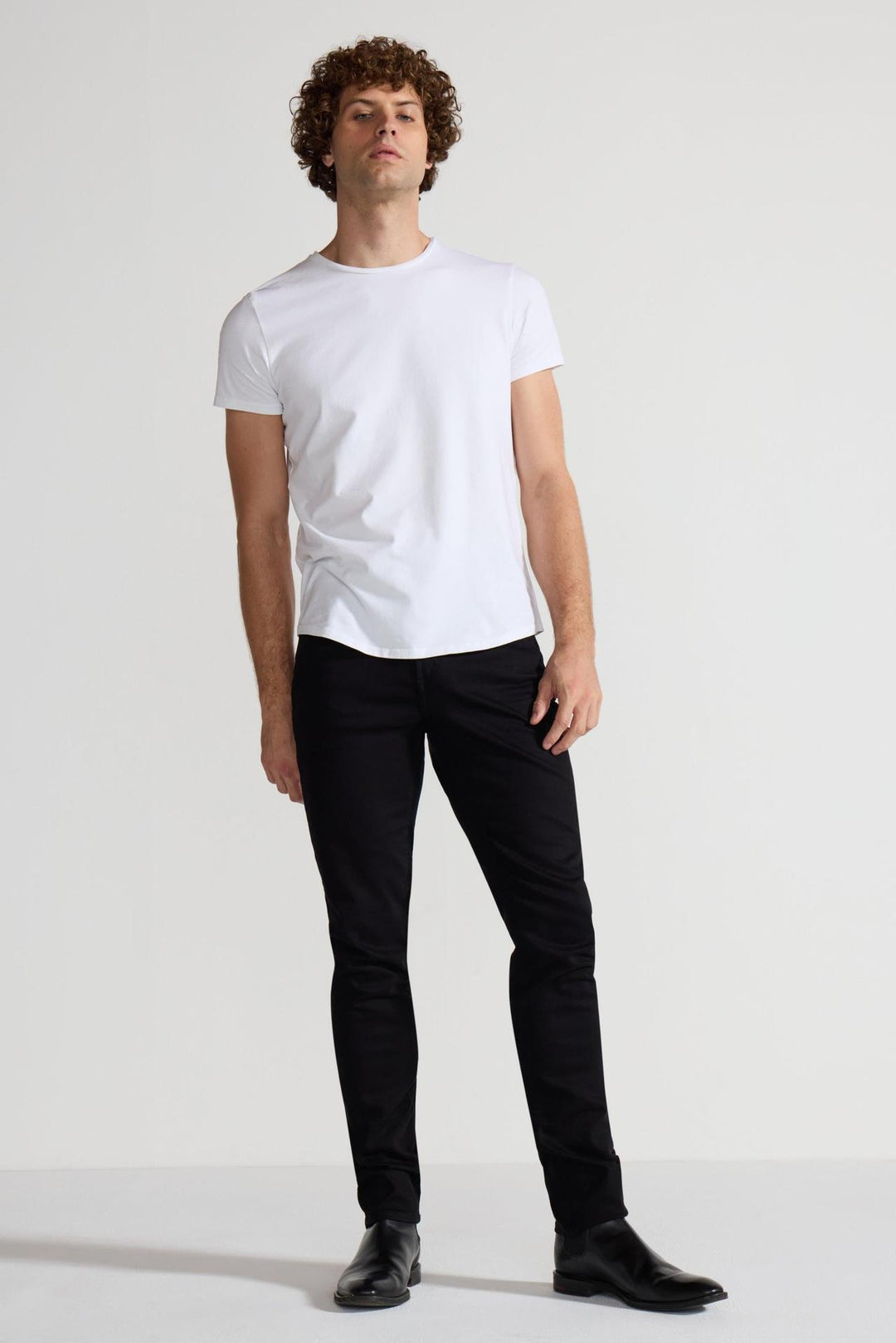 Model wearing MONFRÈRE Greyson Noir men's black Japanese stretch denim five pocket skinny jean.