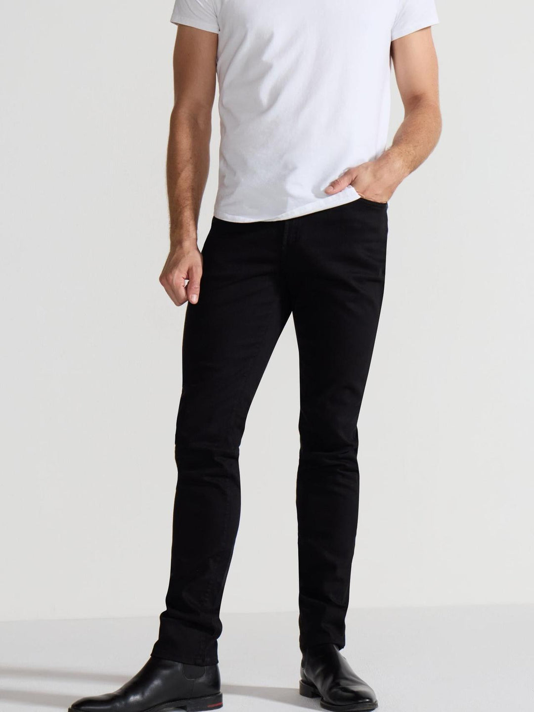 Front profile of MONFRÈRE Greyson Noir men's black Japanese stretch denim five pocket skinny jean.