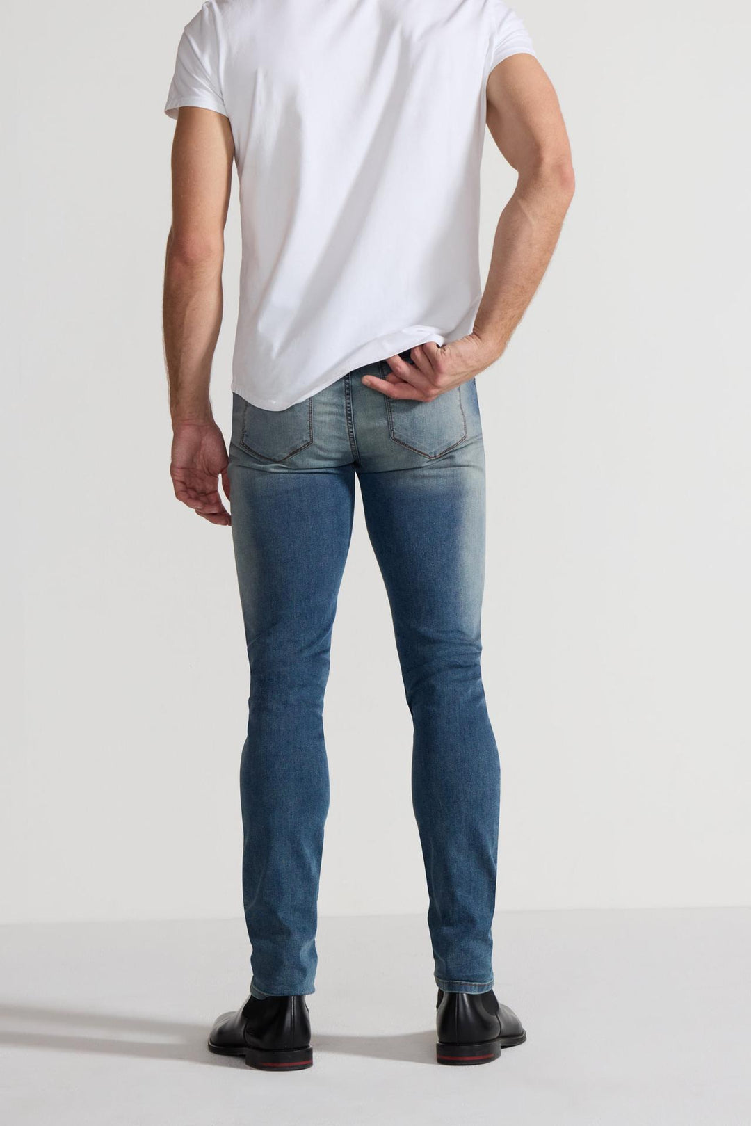Back profile of MONFRÈRE Greyson Tinted Indigo men's dark blue Japanese stretch denim five pocket skinny jean.