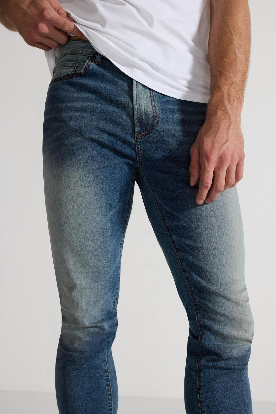 Detail view of MONFRÈRE Greyson Tinted Indigo men's dark blue Japanese stretch denim five pocket skinny jean.