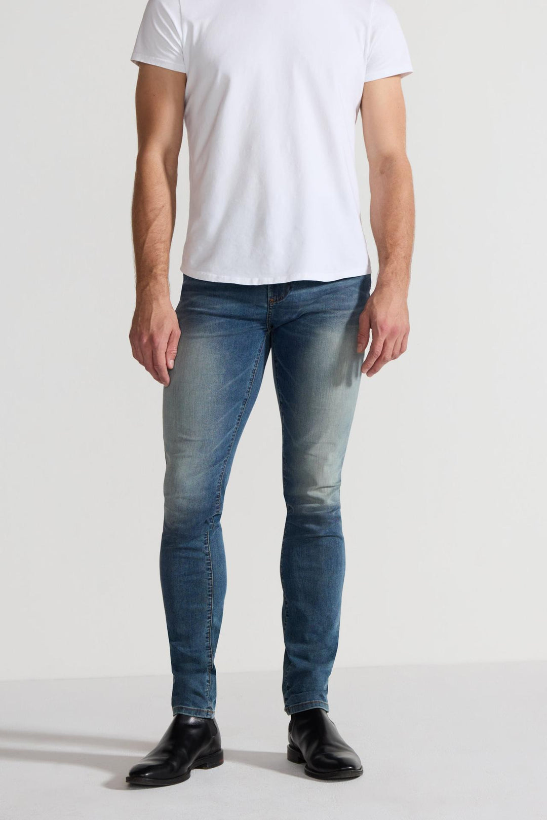 Front profile of MONFRÈRE Greyson Tinted Indigo men's dark blue Japanese stretch denim five pocket skinny jean.