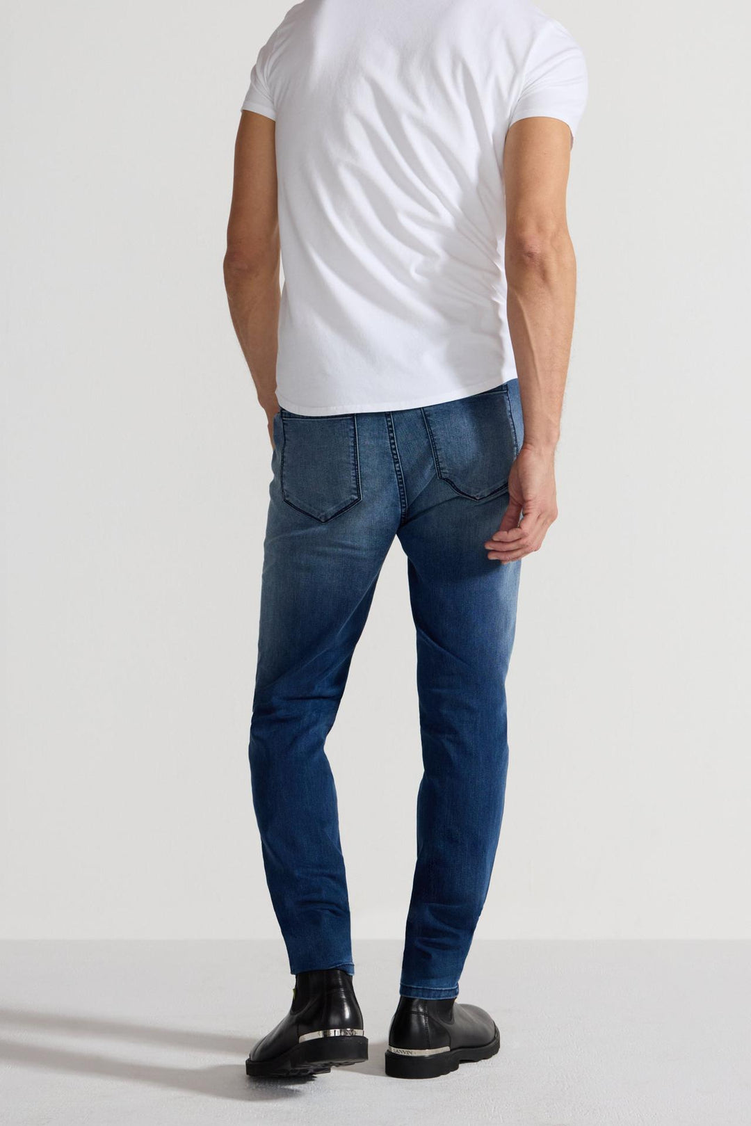 Back profile of MONFRÈRE Greyson Toulouse men's dark blue Japanese stretch denim five pocket skinny jean.