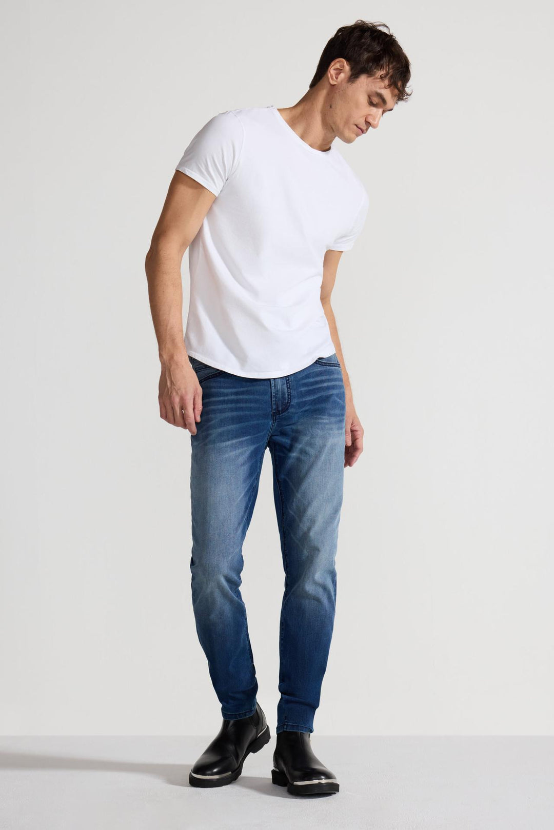 Model wearing MONFRÈRE Greyson Toulouse men's dark blue Japanese stretch denim five pocket skinny jean.