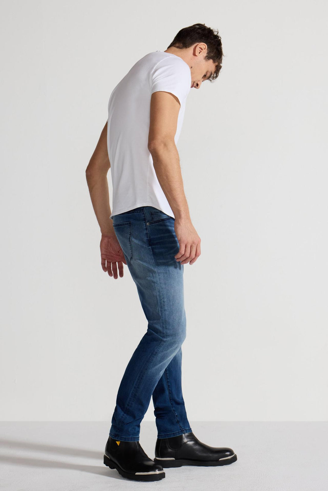 Side profile of MONFRÈRE Greyson Toulouse men's dark blue Japanese stretch denim five pocket skinny jean.