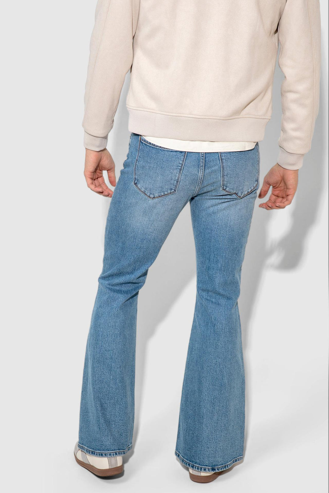 Back profile of MONFRÈRE Hendrix Calabasas men's blue stretch rigid denim five pocket super flare leg jean.