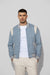 Front profile of MONFRÈRE Jeter Varsity Suede Carolina men's blue soft faux suede stretch fabric varsity jacket.