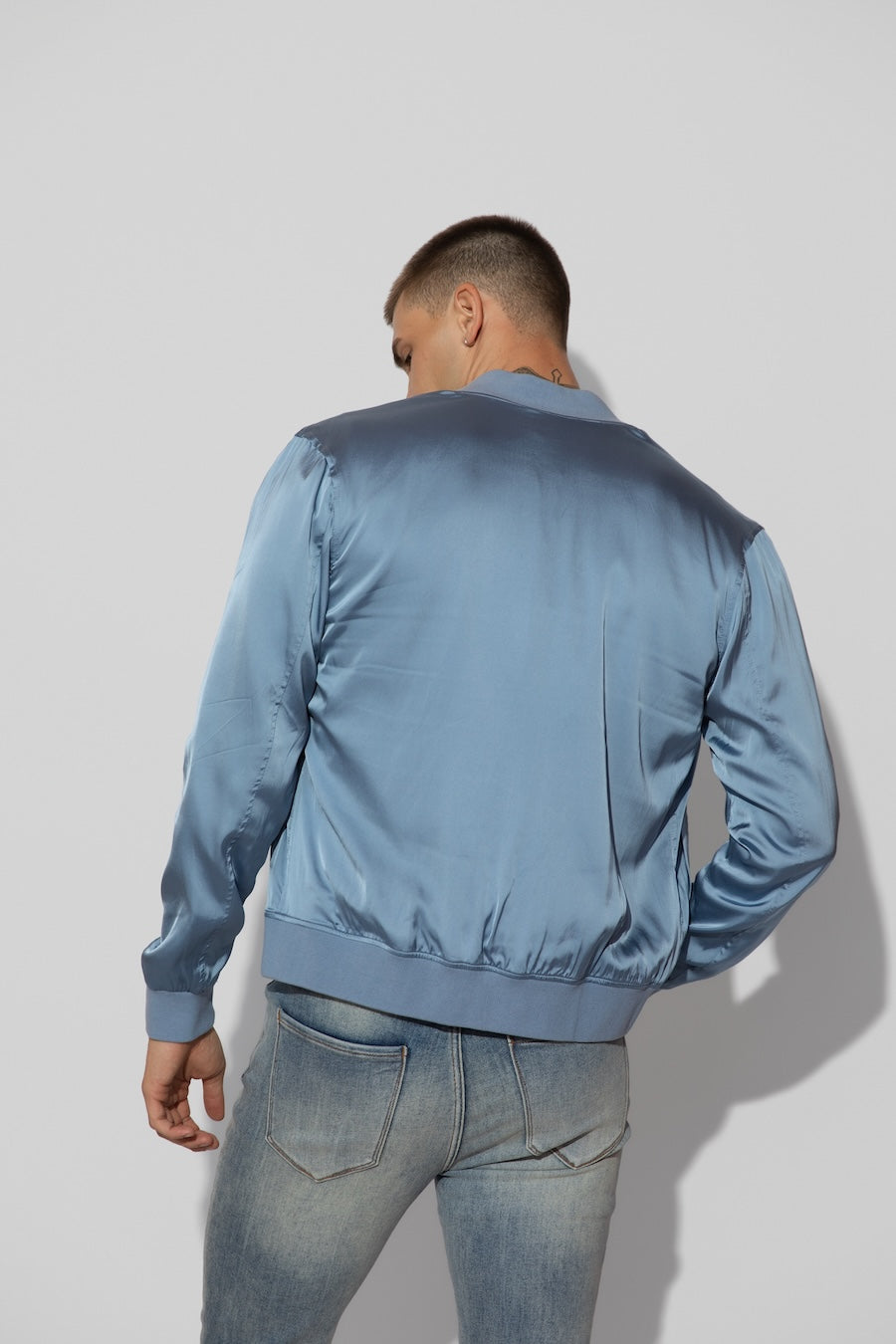 Back profile of MONFRÈRE Maverick Silk Steel Blue men's blue stretch viscose silk bomber jacket.