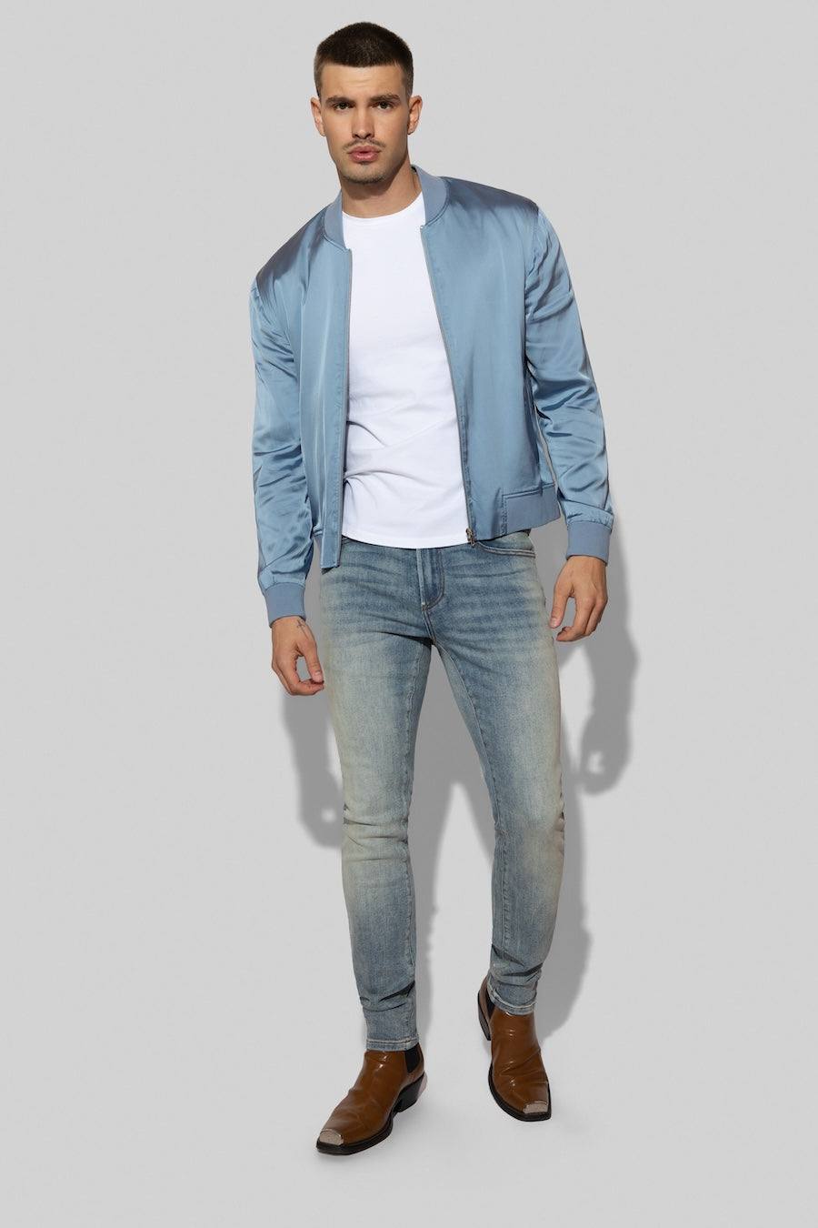 Model wearing MONFRÈRE Maverick Silk Steel Blue men's blue stretch viscose silk bomber jacket.