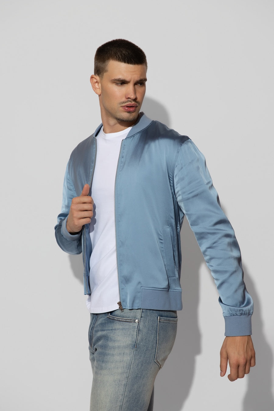 Side profile of MONFRÈRE Maverick Silk Steel Blue men's blue stretch viscose silk bomber jacket.