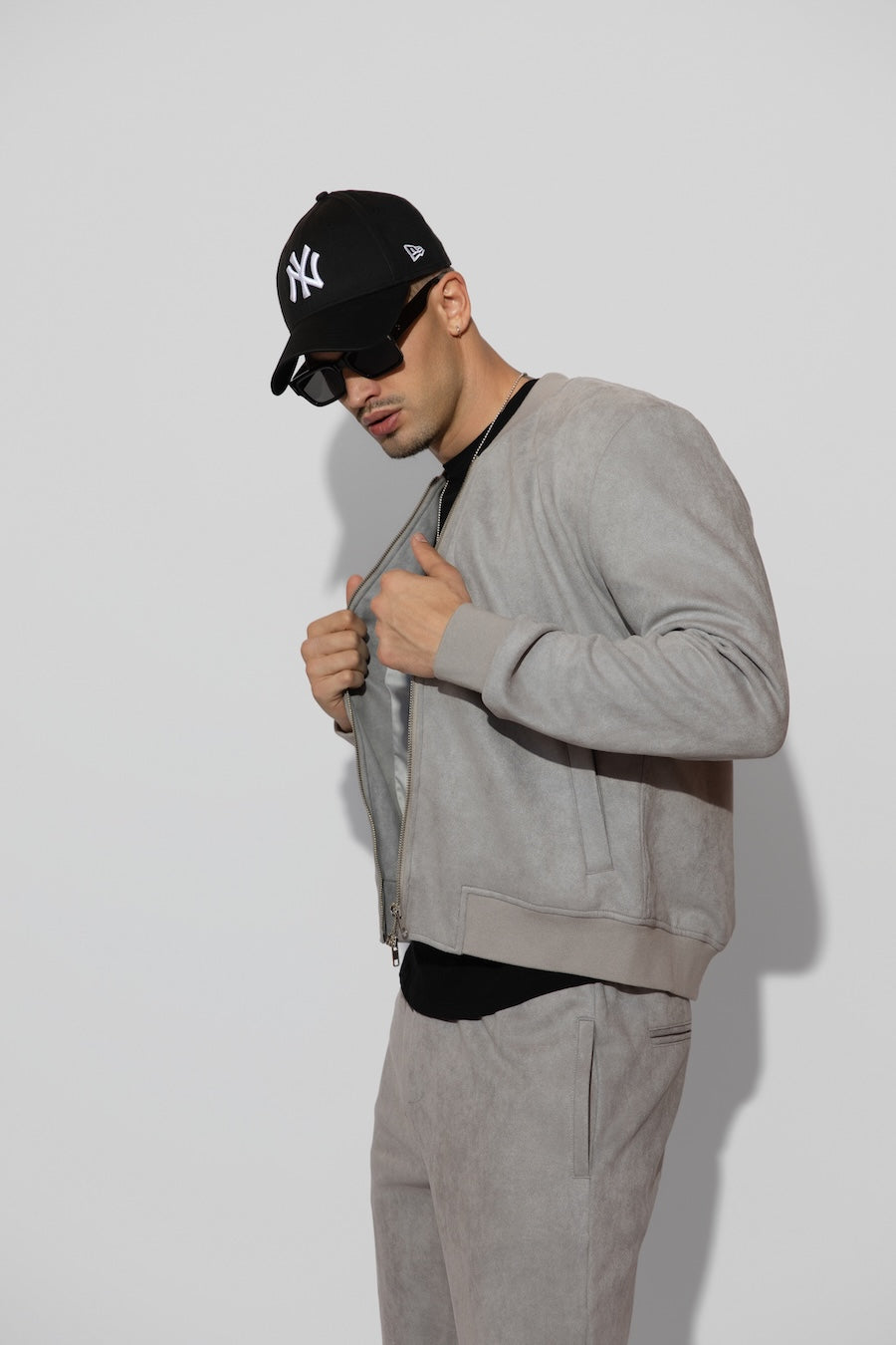 Side profile of MONFRÈRE Maverick Butter Suede Cool Grey men's light grey soft faux suede stretch fabric bomber jacket.